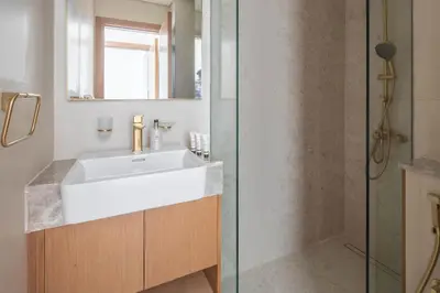 a bathroom with a sink and a shower at Frank Porter - Binghatti Tulip in Dubai
