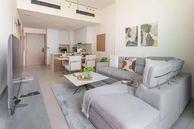 a living room with a couch and a table at Frank Porter - Binghatti Amber in Dubai