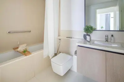 a bathroom with a toilet and a tub and a sink at Frank Porter - Burj Crown in Dubai