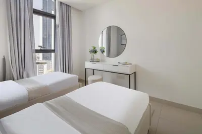 a hotel room with two beds and a mirror at Frank Porter - Burj Crown in Dubai