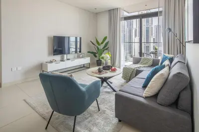 a living room with a couch and a tv at Frank Porter - Burj Crown in Dubai