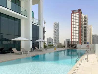 a large swimming pool on top of a building at VayK - Cozy Stylish 1BR in JVC in Dubai