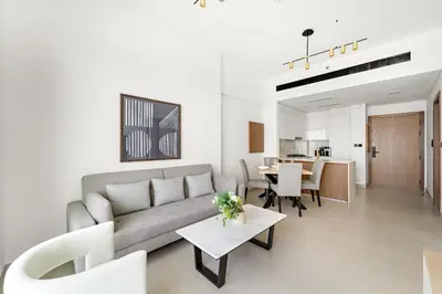 a living room with a couch and a table at VayK - Cozy Stylish 1BR in JVC in Dubai