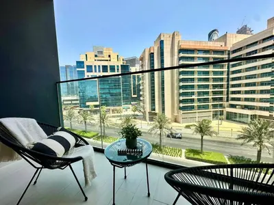 a living room with a large window with a view of a city at Artful Canal Escape With Jacuzzi And City Views! in Dubai