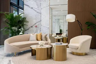 a lobby with a couch and two chairs and tables at Artful Canal Escape With Jacuzzi And City Views! in Dubai