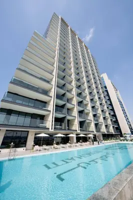a large building with a swimming pool in front of it at Artful Canal Escape With Jacuzzi And City Views! in Dubai