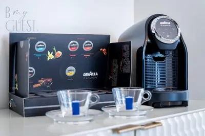 a coffee machine with two cups on a counter at Spice of Sophistication in a 2BR Downtown Views II in Dubai