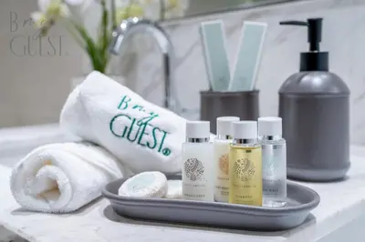 a tray with toiletries and towels on a bathroom counter at Spice of Sophistication in a 2BR Downtown Views II in Dubai