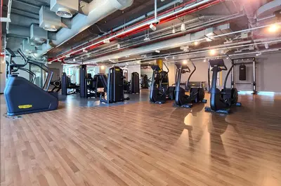 a gym with lots of treadmills and elliptical machines at Spice of Sophistication in a 2BR Downtown Views II in Dubai