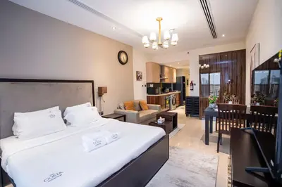 a bedroom with a large bed and a living room at Elite Haven, Elegant Escape in Dubai - Free Pool in Dubai