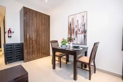 a dining room with a table and two chairs at Elite Haven, Elegant Escape in Dubai - Free Pool in Dubai