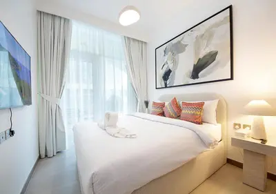 a bedroom with a white bed with a large window at Urban Oasis 2BR Retreat in Dubai with Pool View in Dubai