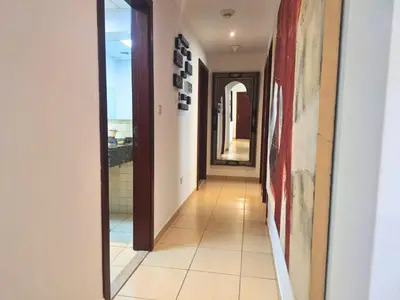 a hallway with a mirror and a tile floor at Tratoli JBR Shared Hostel with Sea View in Dubai