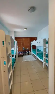a room with several bunk beds in a room at Tratoli JBR Shared Hostel with Sea View in Dubai