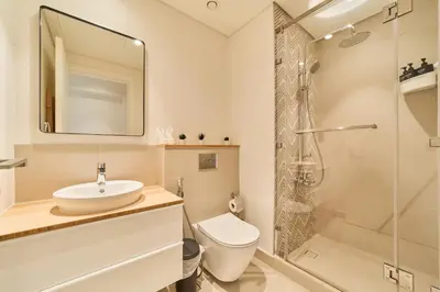 a bathroom with a toilet and a sink and a shower at Chic 1BR With Balcony in Collective 2 Dubai Hills in Dubai
