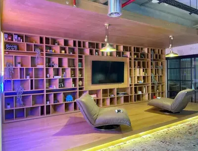 a living room with two chairs and a television at Chic 1BR With Balcony in Collective 2 Dubai Hills in Dubai