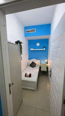 a small room with a bed and a table at Solo Cabin Room in Tecom Barsha Heights in Dubai