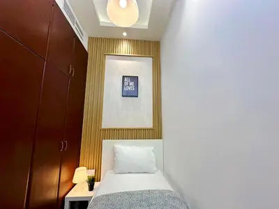a small bedroom with a bed and a picture at Retreat One Room In Tecom Barsha Heights in Dubai