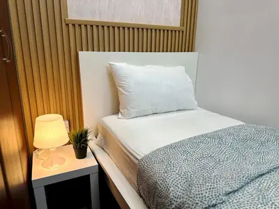 a bedroom with a bed and a lamp on a table at Retreat One Room In Tecom Barsha Heights in Dubai