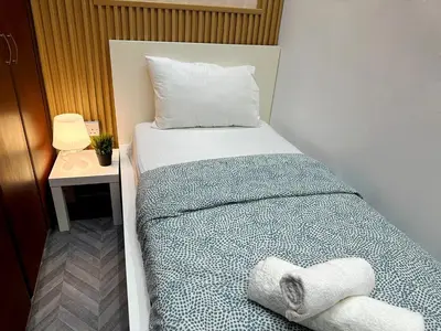 a bedroom with a bed with towels on it at Retreat One Room In Tecom Barsha Heights in Dubai