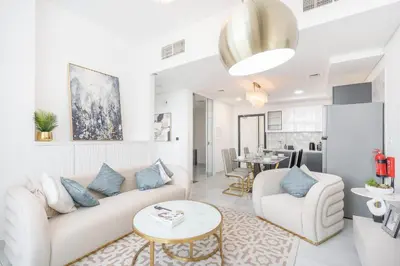 a living room with a couch and a table at StayShort - Beautiful Al Furjan 2 bed apartment for 4 people in Dubai