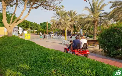 a group of people riding on a motor bike in a park at Lotel Al Barsha 1 at the Mall in Dubai