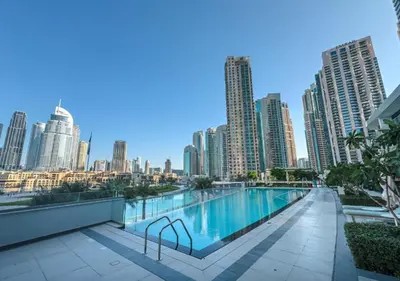 a swimming pool on the roof of a building with a city skyline at Grande Signature Residence by Hogar in Dubai