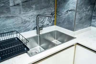 a kitchen sink with a faucet on a counter at High-Rise Comfort 2BR in Nobles Tower in Dubai in Dubai