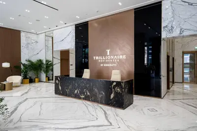 a lobby of a building with a marble floor at Luxe Studio Retreat Jacuzzi Parking, Pool & Gym in Dubai