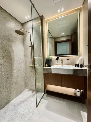 a bathroom with a sink and a shower at Luxe Studio Retreat Jacuzzi Parking, Pool & Gym in Dubai