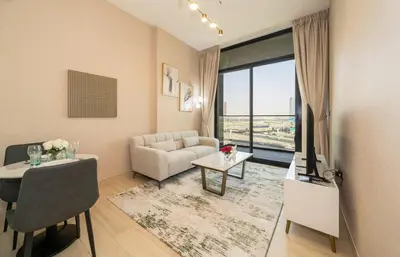 a living room with a couch and a table at Stylish 1BR Apartment in Binghatti Luna JVC Dubai in Dubai