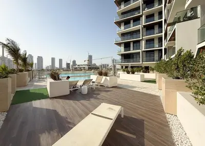 a balcony of a building with benches and a pool at Stylish 1BR Apartment in Binghatti Luna JVC Dubai in Dubai