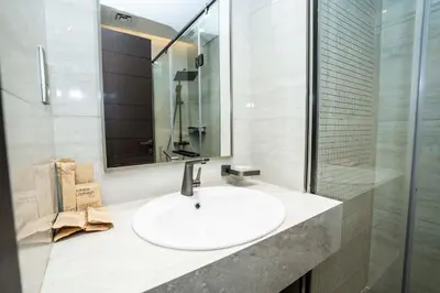 a bathroom with a white sink and a mirror at Modern 2BR Apartment Nobles Tower Dubai Views in Dubai