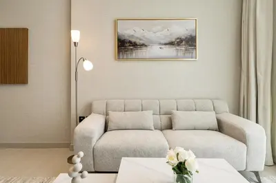a living room with a couch and a table at Luxury 1BR Apt Binghatti Amber Prime Location in Dubai