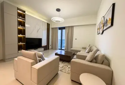 a living room with two couches and a television at Elegant Style Brand new 2BDR in Heart of Downtown in Dubai