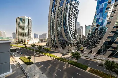 an aerial view of a city with tall buildings at Stylish Studio With Pool View Mins to Dubai Mall in Dubai