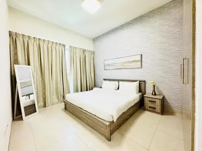 a bedroom with a white bed and a window at Luxury 1BR The Bay Scenic Canal Creek Outlook in Dubai
