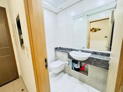 a white bathroom with a sink and a toilet at Luxury 1BR The Bay Scenic Canal Creek Outlook in Dubai