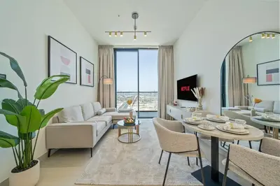 a living room with a couch and a table at Comfortable 1-Bedroom Getaway Binghatti House in Dubai