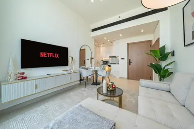 a living room with a tv on a wall at Skyline Views from Binghatti House in Dubai