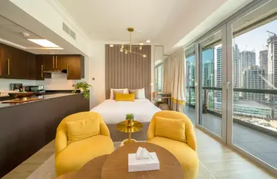 a hotel room with a bed and a table and chairs at Stylish Studio Steps from Burj Khalifa Fountains in Dubai