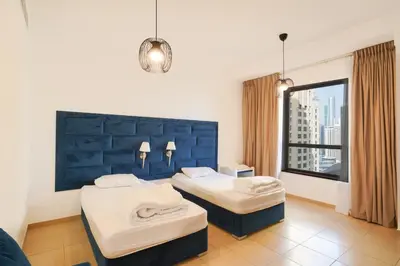 a hotel room with two beds and a window at Spacious 2 Bedroom in JBR with beach access in Dubai