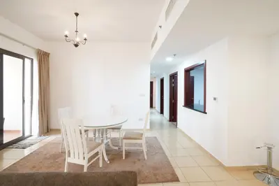 a dining room with a white table and chairs at Spacious 2 Bedroom in JBR with beach access in Dubai