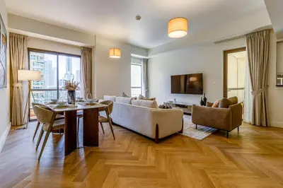 a living room with a couch and a table at Rimal 1 in JBR - 1 Bedroom Apartment - Allsopp & Allsopp in Dubai