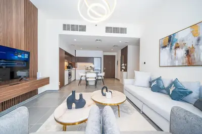 a living room with a couch and a table at Modern 1 BR in Creek Edge Ideal Family Living in Dubai