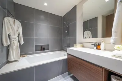 a bathroom with a tub and a sink at Modern 1 BR in Creek Edge Ideal Family Living in Dubai
