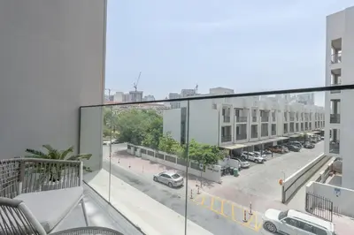 an apartment balcony with a view of a street at Chic Duplex 1BHK by CzechIn Luxe Stay with Pool Gym in Dubai