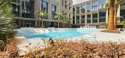 a swimming pool in front of a building at Chic Duplex 1BHK by CzechIn Luxe Stay with Pool Gym in Dubai