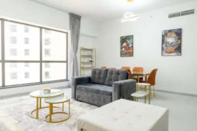 a living room with a couch and a table at Nasma Luxury Stays - Jacuzzi Dreams 1 BR in Jumeirah in Dubai