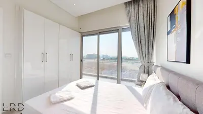 a bedroom with a bed and a large window at Chic & Cozy 1BR in Centurion Onyx in Dubai